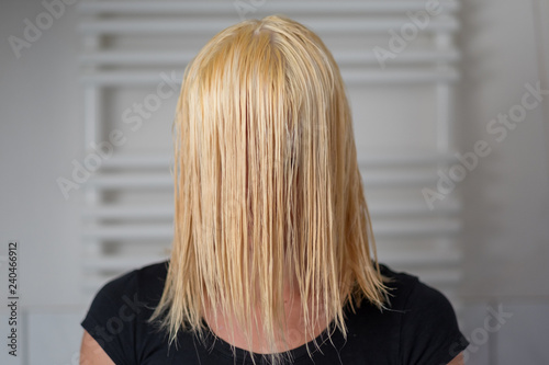 Blond woman with shoulder length wet hair