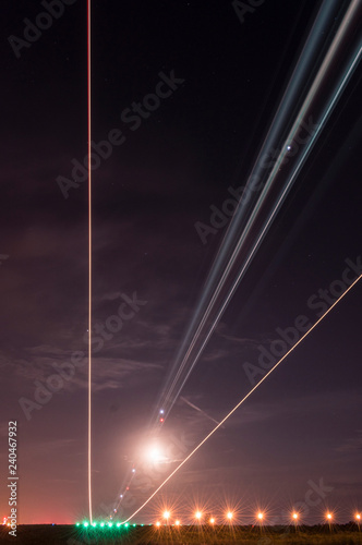 Lights in the sky from landing plane in the evening.