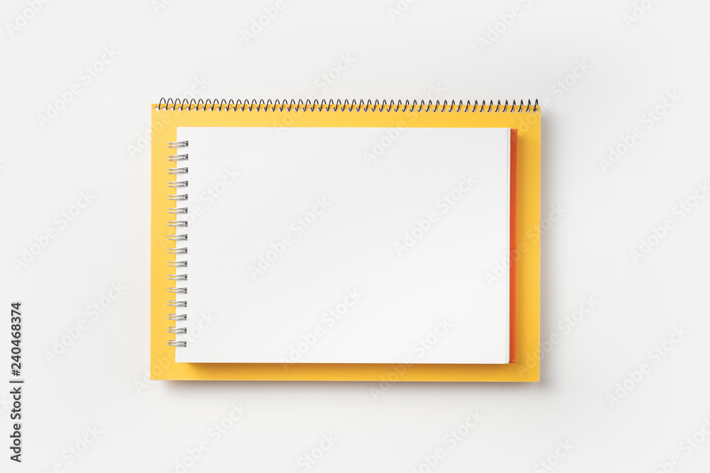 Top view of yellow and red spiral notebook Top view of yellow and red spiral notebook
