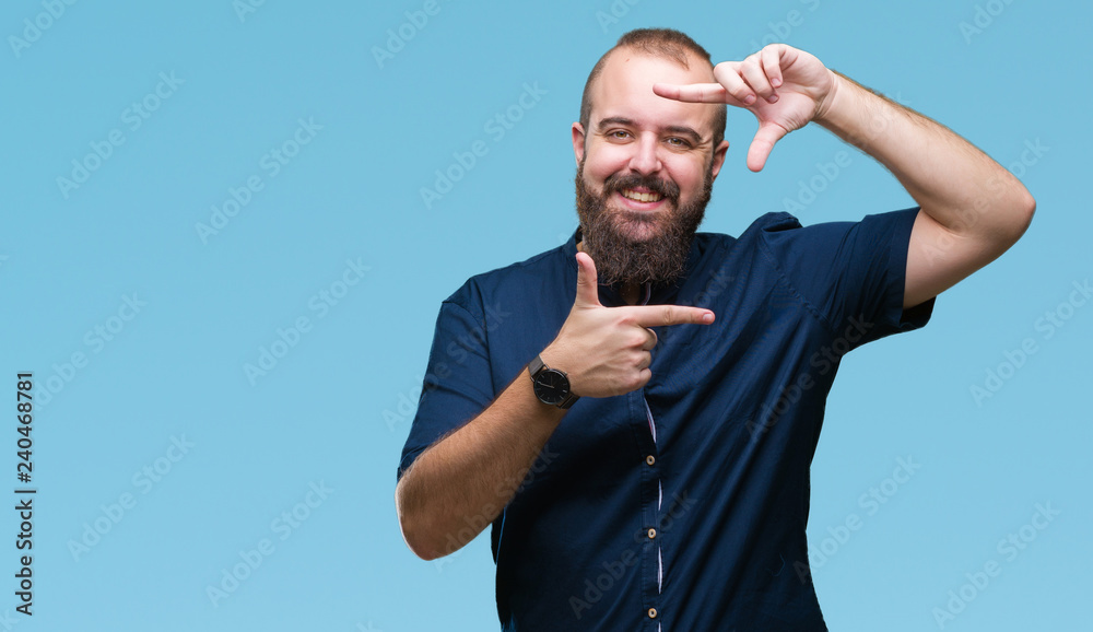 Fototapeta premium Young caucasian hipster man over isolated background smiling making frame with hands and fingers with happy face. Creativity and photography concept.