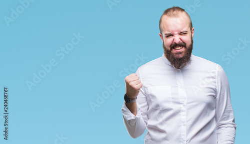 Young caucasian hipster man over isolated background very happy and excited doing winner gesture with arms raised, smiling and screaming for success. Celebration concept.