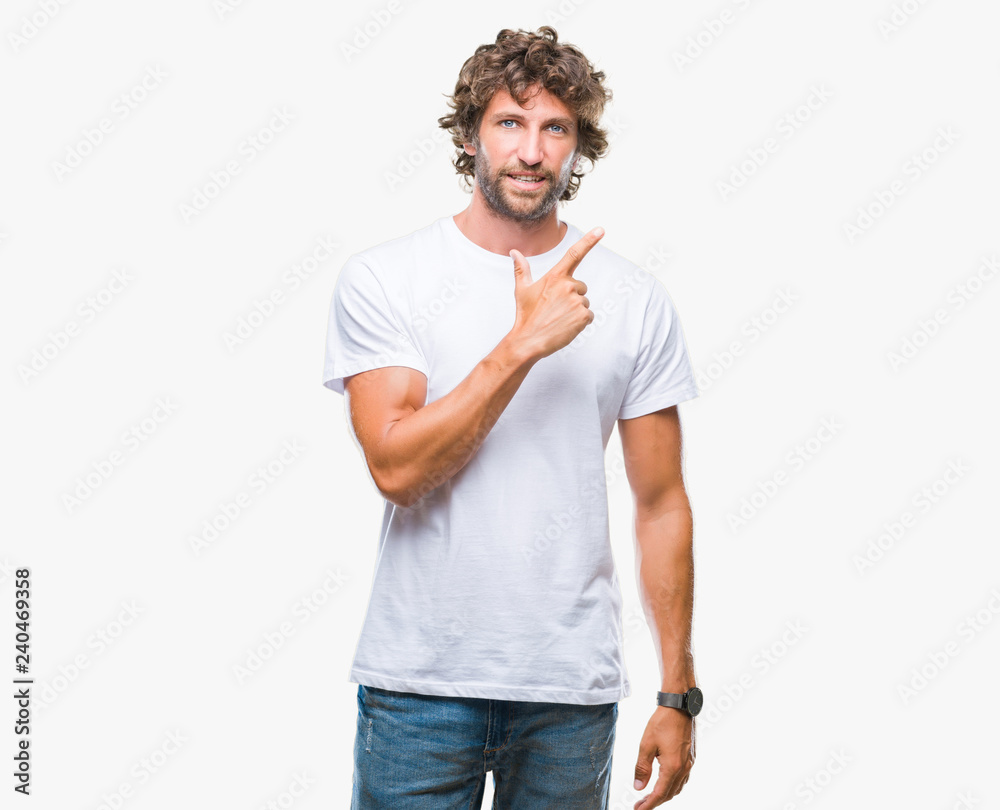 Handsome hispanic model man over isolated background cheerful with a smile of face pointing with hand and finger up to the side with happy and natural expression on face looking at the camera. Handsome hispanic model man over isolated background cheerful with a smile of face pointing with hand and finger up to the side with happy and natural expression on face looking at the camera.