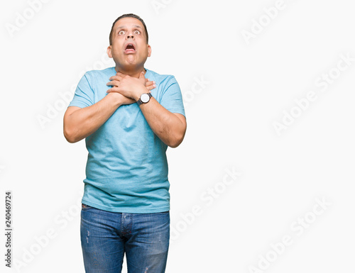 Middle age arab man wearing blue t-shirt over isolated background shouting and suffocate because painful strangle. Health problem. Asphyxiate and suicide concept.