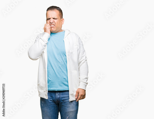 Middle age arab man wearing sweatshirt over isolated background looking stressed and nervous with hands on mouth biting nails. Anxiety problem. © Krakenimages.com