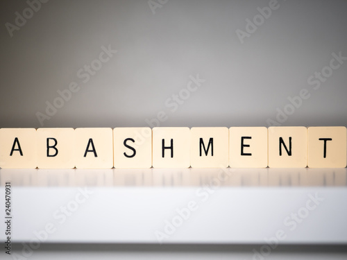 Closeup of abashment word on white table. photo