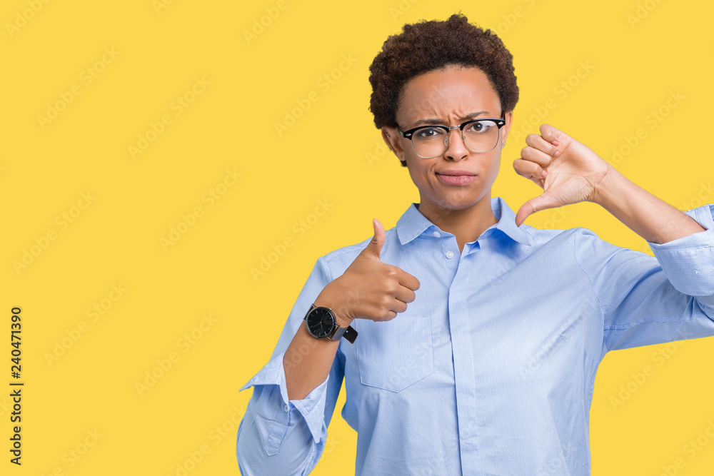 Young beautiful african american business woman over isolated background Doing thumbs up and down, disagreement and agreement expression. Crazy conflict Young beautiful african american business woman over isolated background Doing thumbs up and down, disagreement and agreement expression. Crazy conflict