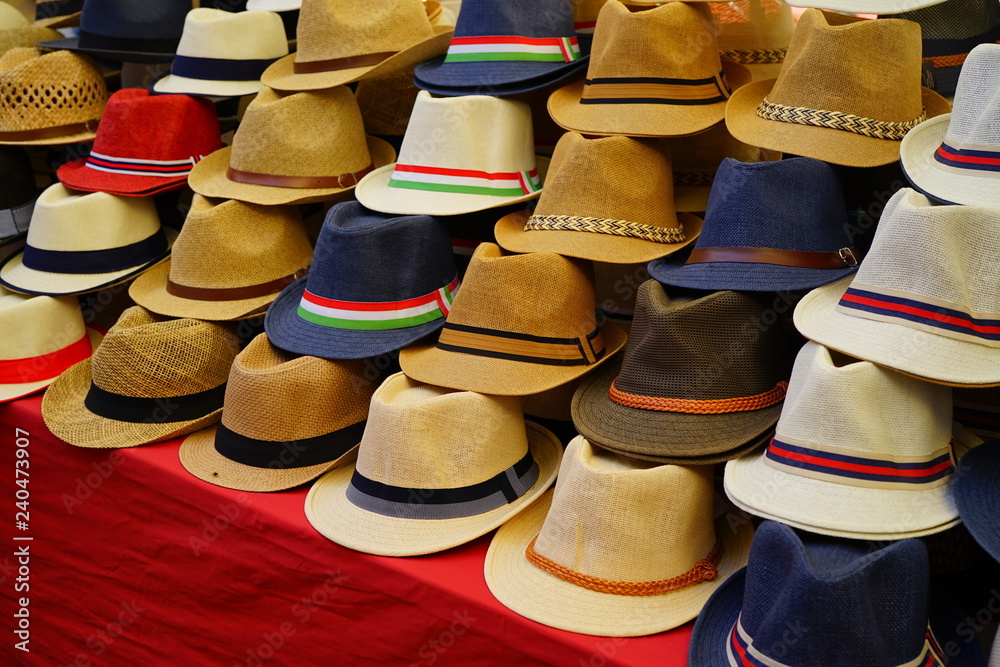 Display of colorful straw hats for sale at an Italian market