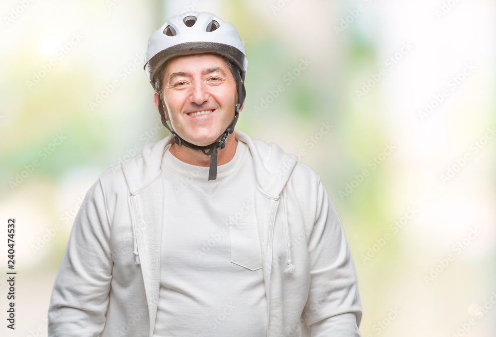 Handsome senior cyclist man wearing bike helmet over isolated background with a happy face standing and smiling with a confident smile showing teeth
