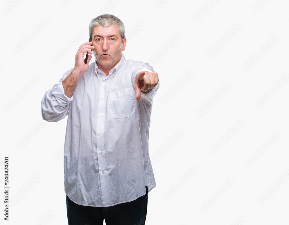 Handsome senior man talking on smartphone over isolated background pointing with finger to the camera and to you, hand sign, positive and confident gesture from the front Handsome senior man talking on smartphone over isolated background pointing with finger to the camera and to you, hand sign, positive and confident gesture from the front