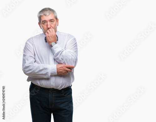 Handsome senior man wearing bow tie over isolated background looking stressed and nervous with hands on mouth biting nails. Anxiety problem. © Krakenimages.com