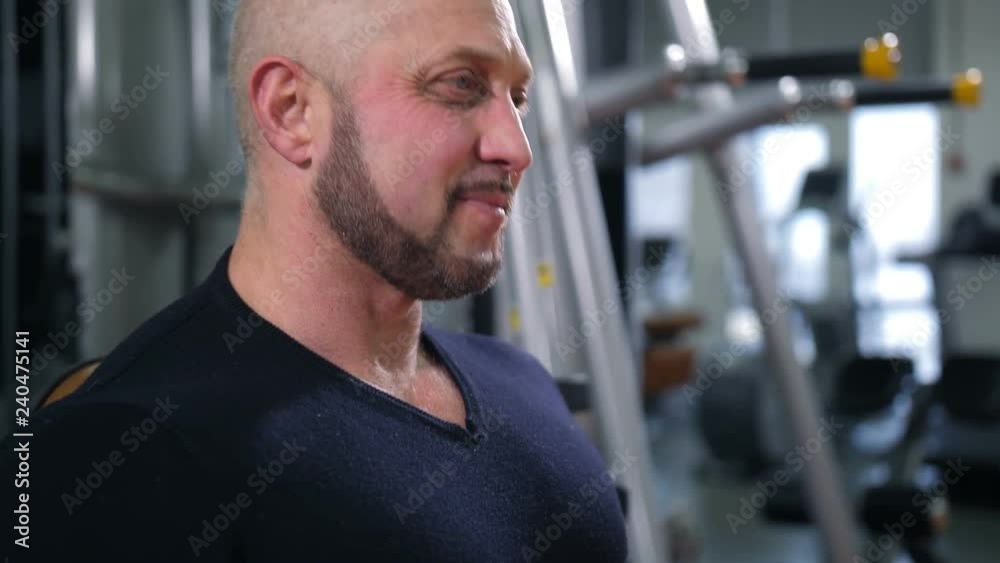 Adult bodybuilder straining chest muscles and smiling 4K Slow Mo Adult bodybuilder straining chest muscles and smiling 4K Slow Mo