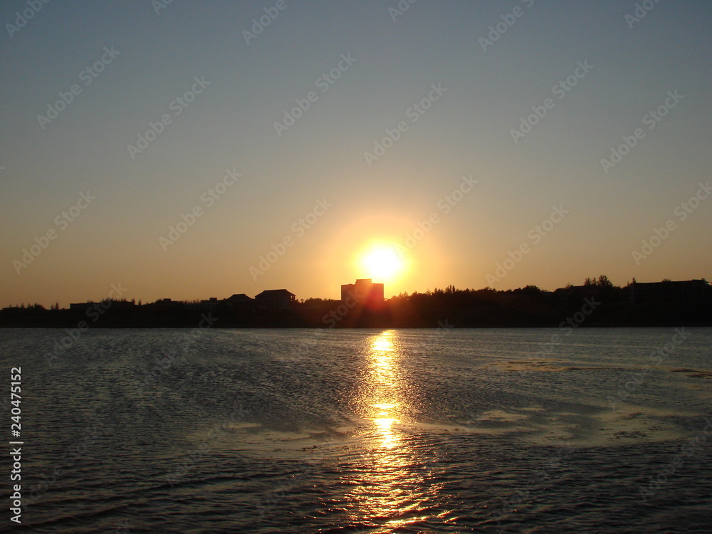 Sunny road on the water surface of the Gulf of the Azov Sea at sunset.