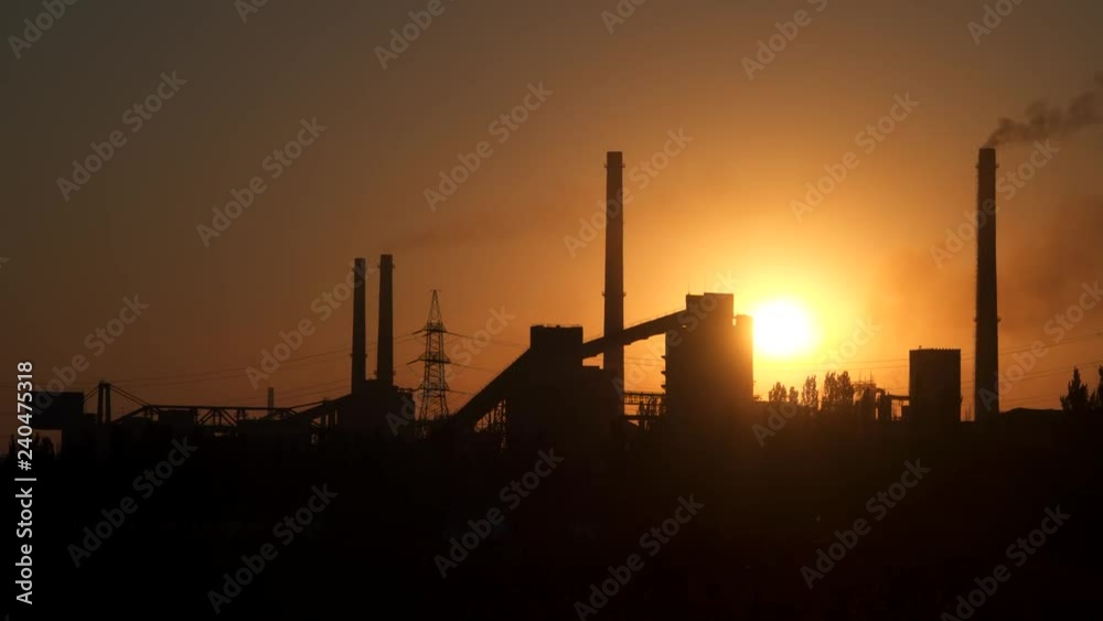 Industrial enterprise on the background of the sun at sunrise. Industrial enterprise on the background of the sun at sunrise.