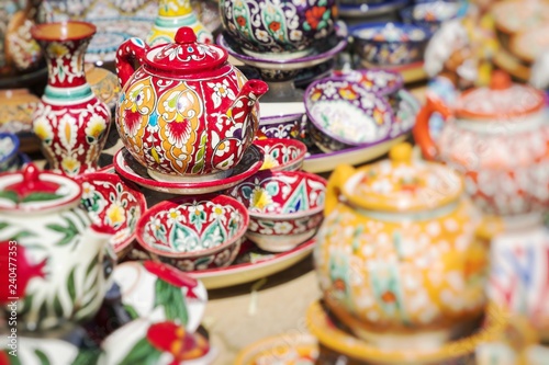 Plates and pots on a street market in Uzbekistan. Selective Focus. © Curioso.Photography
