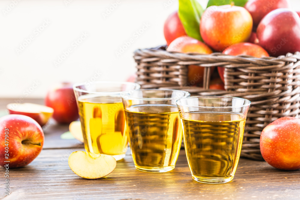 Apples juice in glass with apple in the basket