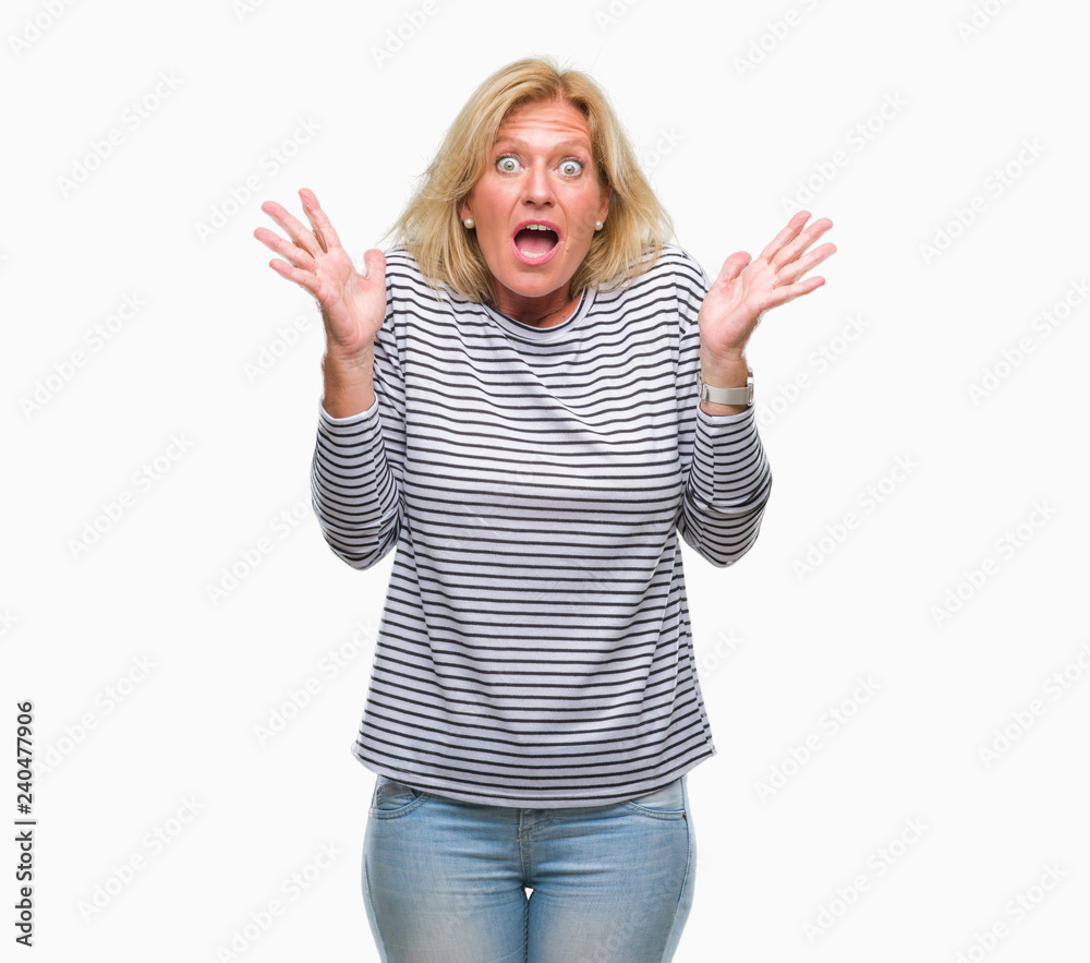 Middle age blonde woman over isolated background celebrating crazy and amazed for success with arms raised and open eyes screaming excited. Winner concept Middle age blonde woman over isolated background celebrating crazy and amazed for success with arms raised and open eyes screaming excited. Winner concept