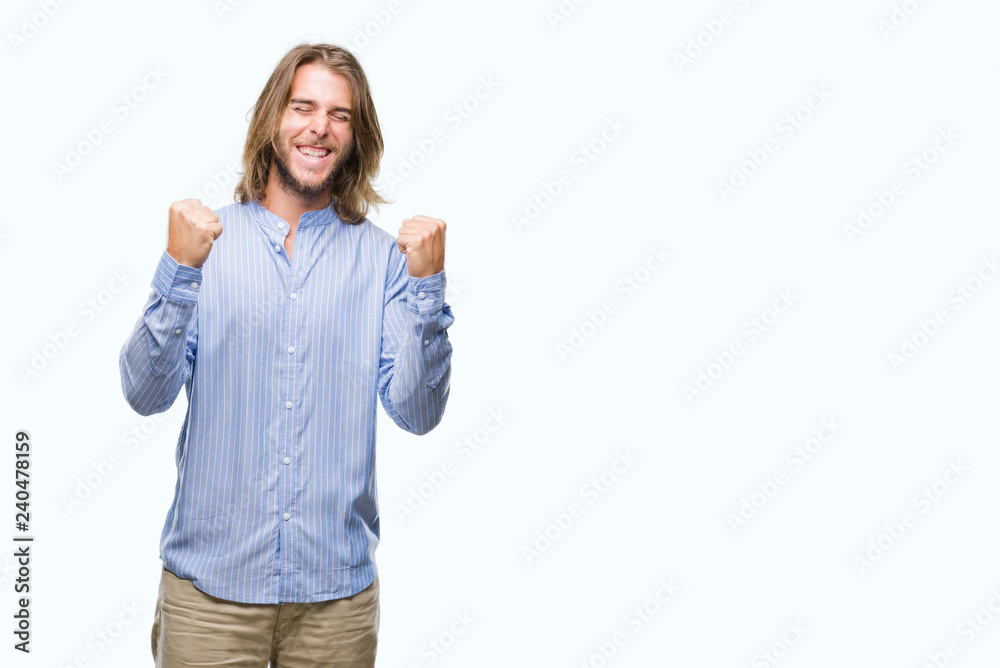 Young handsome man with long hair over isolated background very happy and excited doing winner gesture with arms raised, smiling and screaming for success. Celebration concept. Young handsome man with long hair over isolated background very happy and excited doing winner gesture with arms raised, smiling and screaming for success. Celebration concept.