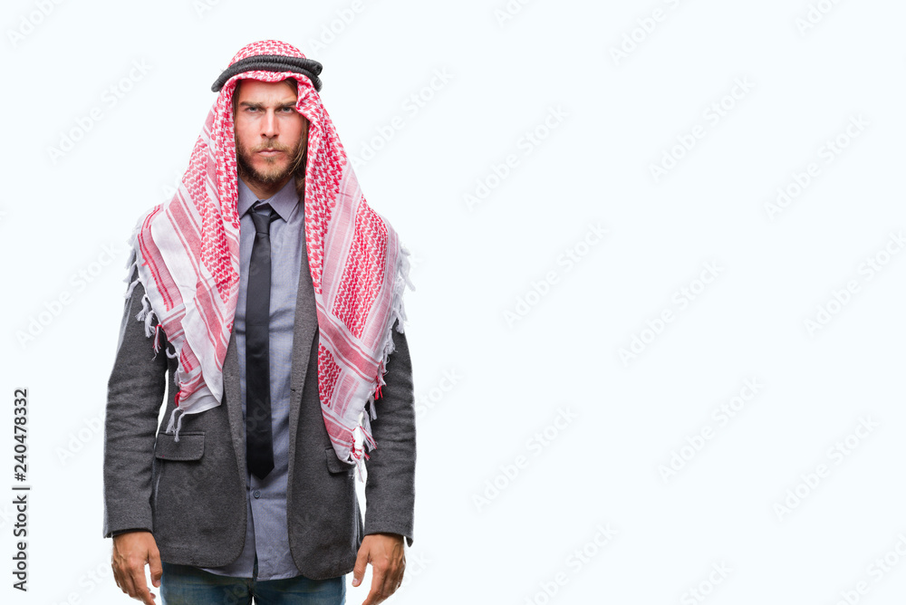 Young handsome arabian man with long hair wearing keffiyeh over isolated background skeptic and nervous, frowning upset because of problem. Negative person. Young handsome arabian man with long hair wearing keffiyeh over isolated background skeptic and nervous, frowning upset because of problem. Negative person.