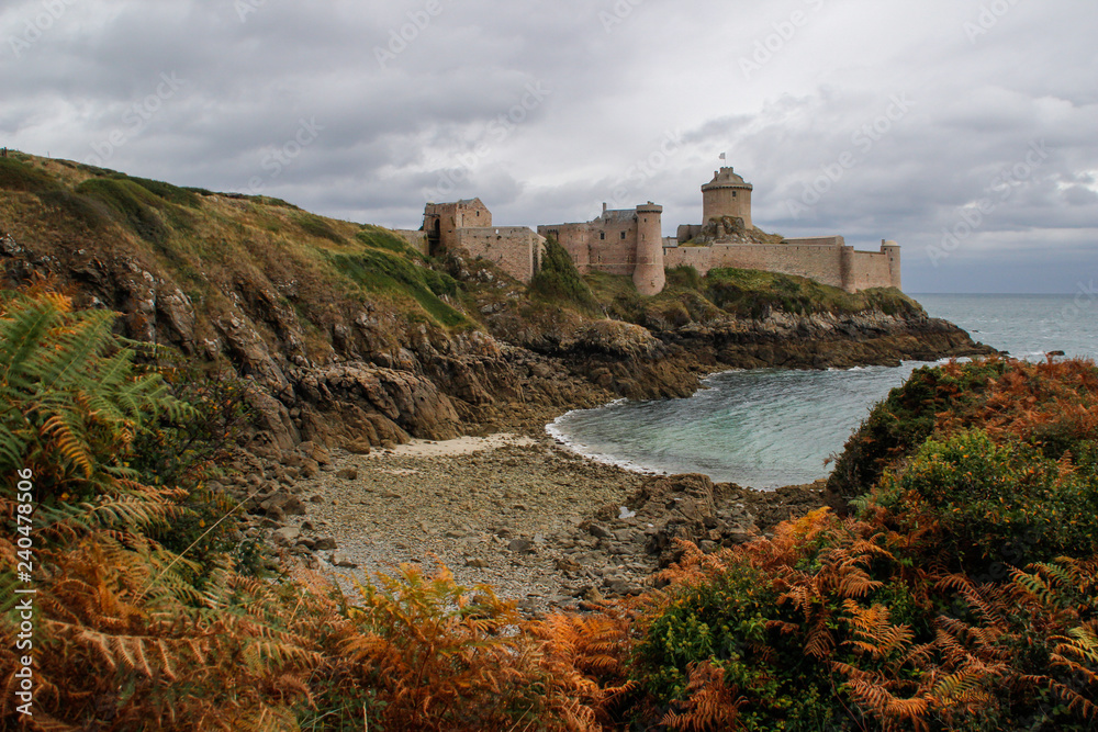 The famous medieval stone castle - fortress la Latte in the fall during a storm on the Celtic Sea in Normandy, France