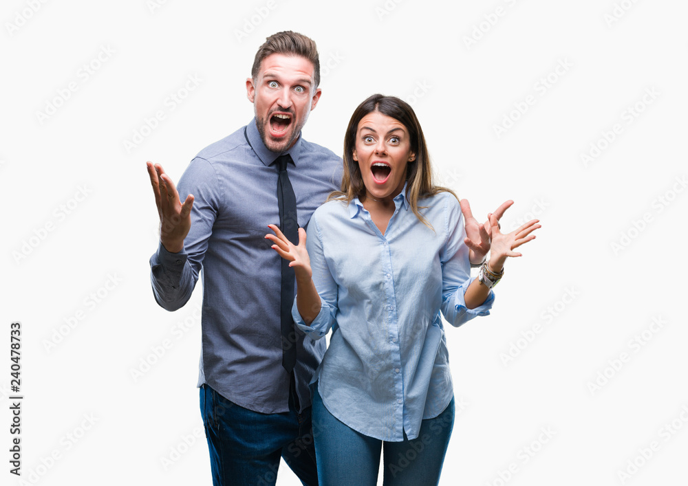 Young workers business couple over isolated background celebrating crazy and amazed for success with arms raised and open eyes screaming excited. Winner concept Young workers business couple over isolated background celebrating crazy and amazed for success with arms raised and open eyes screaming excited. Winner concept