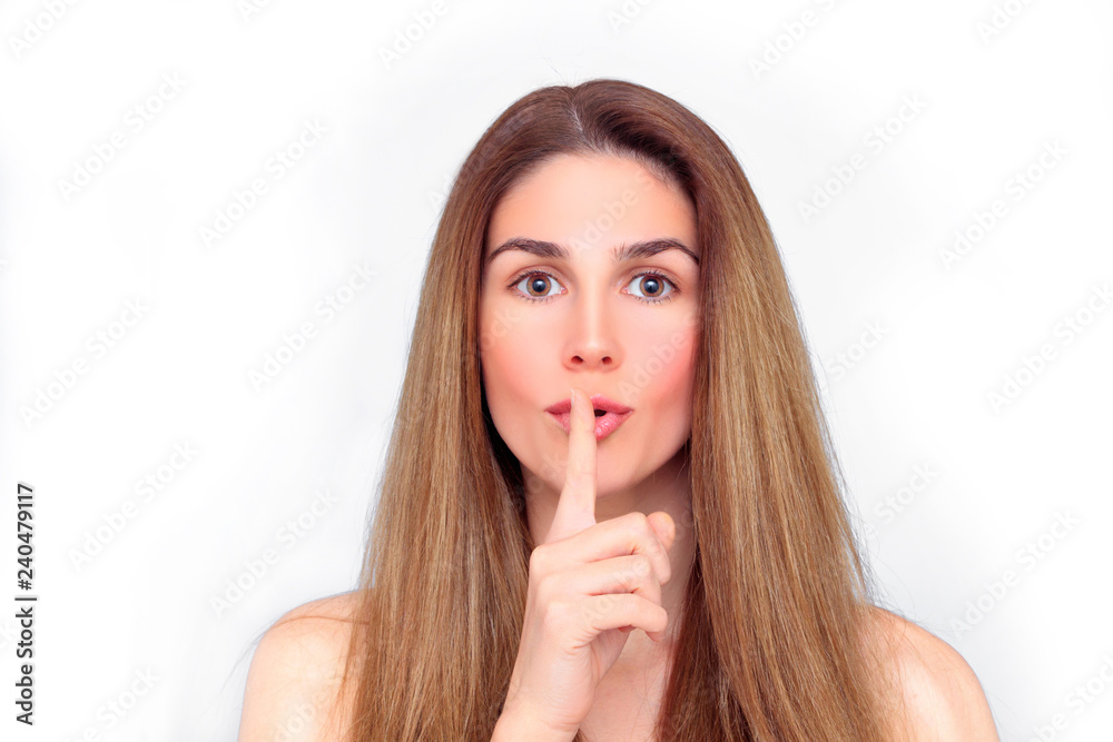 Beautiful woman with finger on her lips silence gesture Beautiful woman with finger on her lips silence gesture