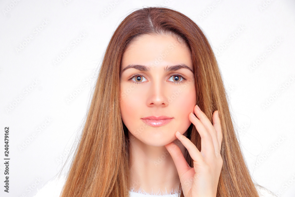 Beautiful woman touches her face with her left hand Beautiful woman touches her face with her left hand