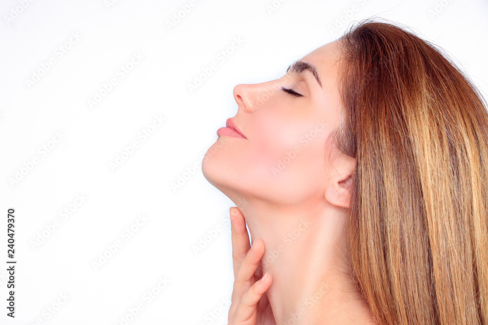 Beautiful woman's face from the side strokes her hand over her neck Beautiful woman's face from the side strokes her hand over her neck