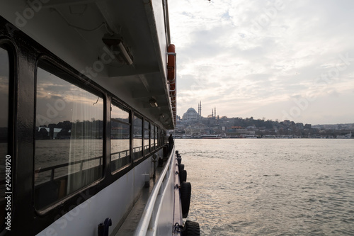 The ferry view with people and seagulls from Istanbul at sunset.