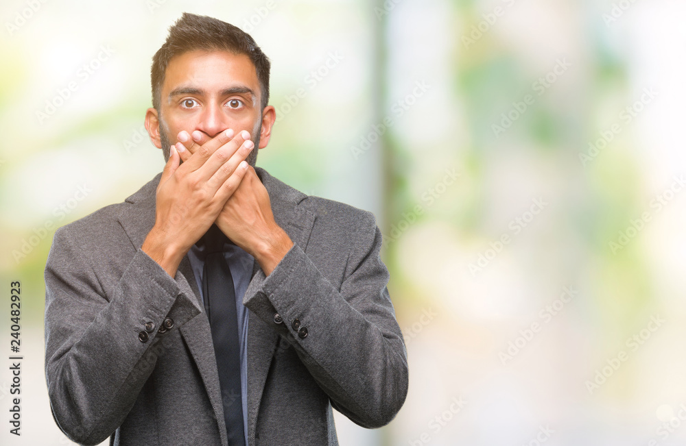 Adult hispanic business man over isolated background shocked covering mouth with hands for mistake. Secret concept. Adult hispanic business man over isolated background shocked covering mouth with hands for mistake. Secret concept.