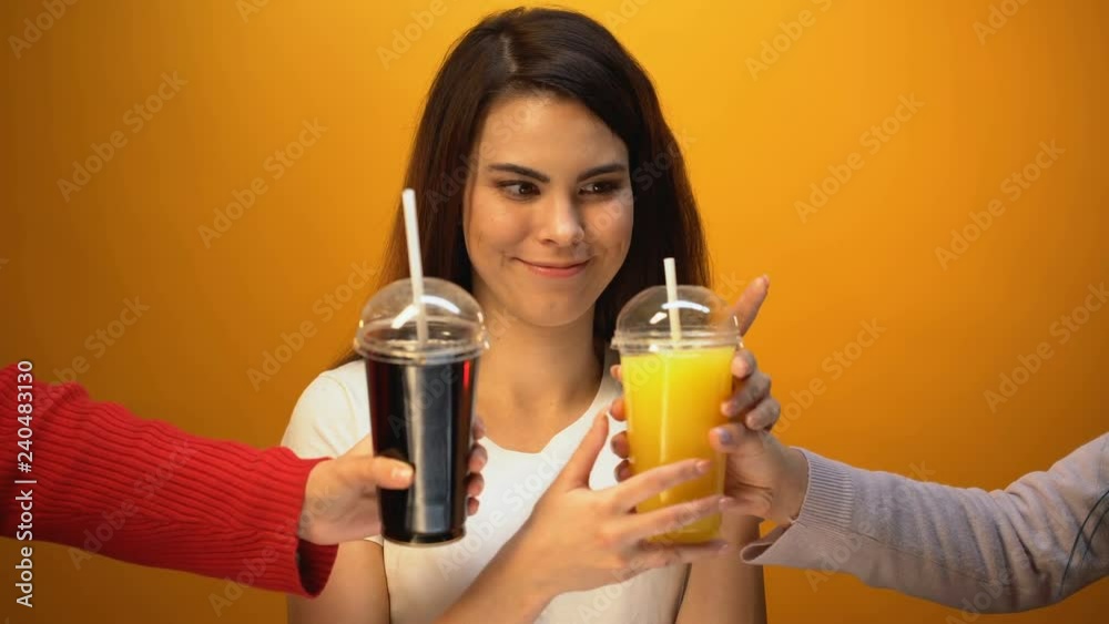 Cute girl choosing orange juice instead of soda, vitamin drink and healthy diet Cute girl choosing orange juice instead of soda, vitamin drink and healthy diet