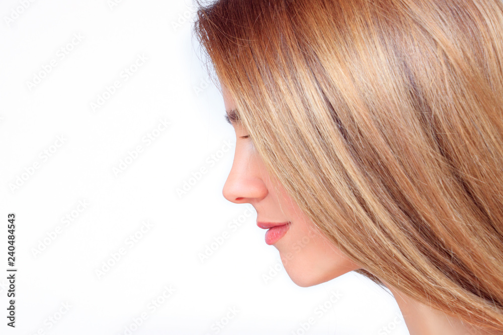 Beautiful woman face with long blond hair from the side looks down Beautiful woman face with long blond hair from the side looks down