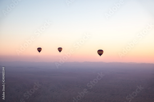 Photography Air balloons over desert during sunrise.
