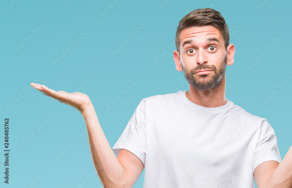 Young handsome man over isolated background clueless and confused expression with arms and hands raised. Doubt concept. Young handsome man over isolated background clueless and confused expression with arms and hands raised. Doubt concept.