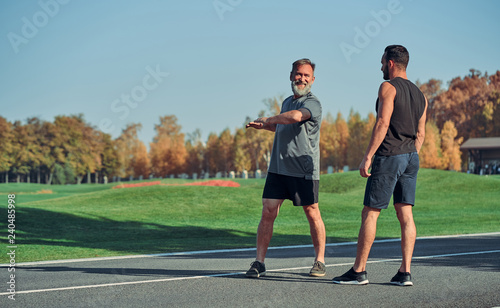 The two men doing exercise outdoor