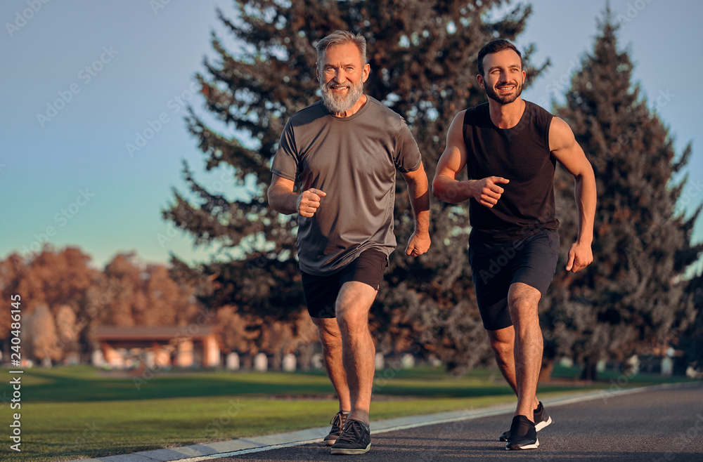 Fototapeta premium The happy father and son running on the road