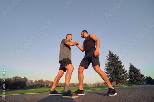 The two opponents holding hands in the park © realstock1