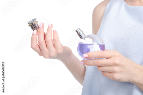 Young woman with perfume bottle on white background, closeup