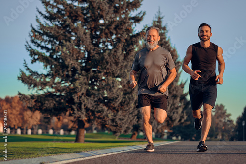 The happy father and son running on the road