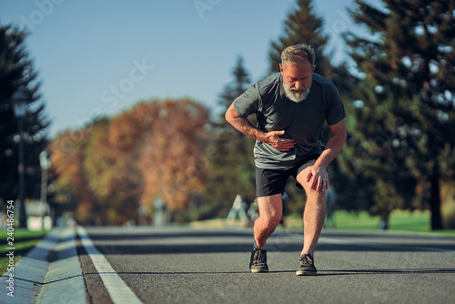 The old runner feeling bad while jogging