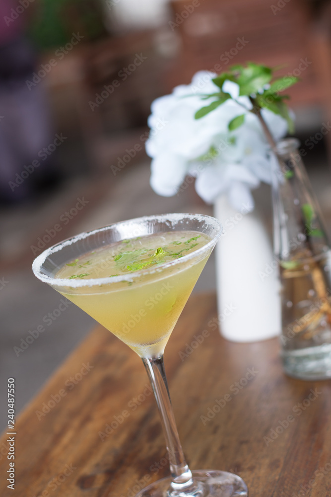 A cocktail of Tequila, lime, mint leaves, and passionfruit A cocktail of Tequila, lime, mint leaves, and passionfruit