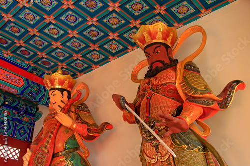 Heavenly Kings holding Pipa and sword statue in Dajue Temple, China photo