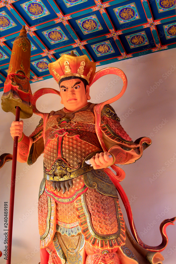 Heavenly Kings holding sword statue in Dajue Temple, China