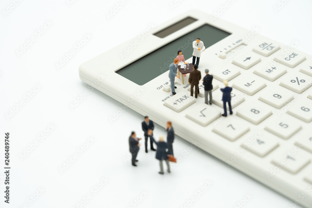 Miniature people Pay queue Annual income (TAX) for the year on calculator. using as background business concept and finance concept with copy space for your text or design. Miniature people Pay queue Annual income (TAX) for the year on calculator. using as background business concept and finance concept with copy space for your text or design.