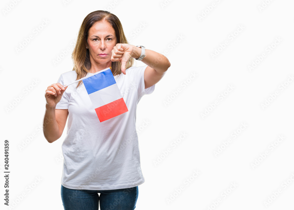 Middle age hispanic woman holding flag of France over isolated background with angry face, negative sign showing dislike with thumbs down, rejection concept Middle age hispanic woman holding flag of France over isolated background with angry face, negative sign showing dislike with thumbs down, rejection concept