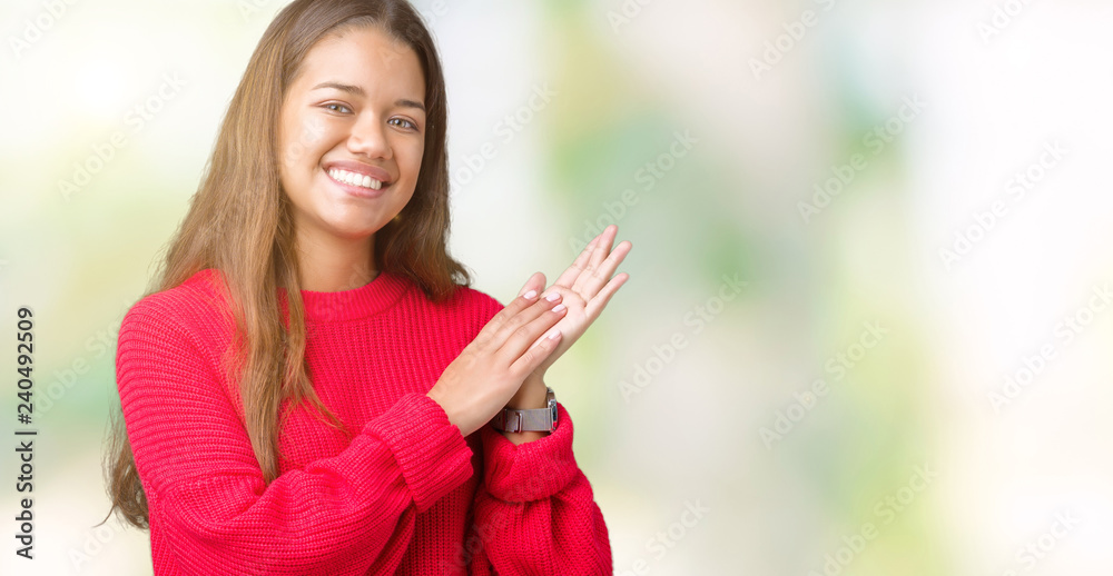 Young beautiful brunette woman wearing red winter sweater over isolated background Clapping and applauding happy and joyful, smiling proud hands together