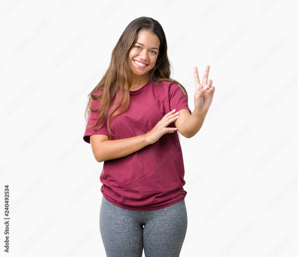 Young beautiful brunette woman over isolated background smiling with happy face winking at the camera doing victory sign. Number two. Young beautiful brunette woman over isolated background smiling with happy face winking at the camera doing victory sign. Number two.