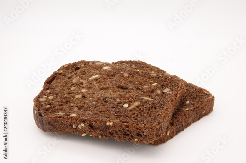 black bread with seeds on white background