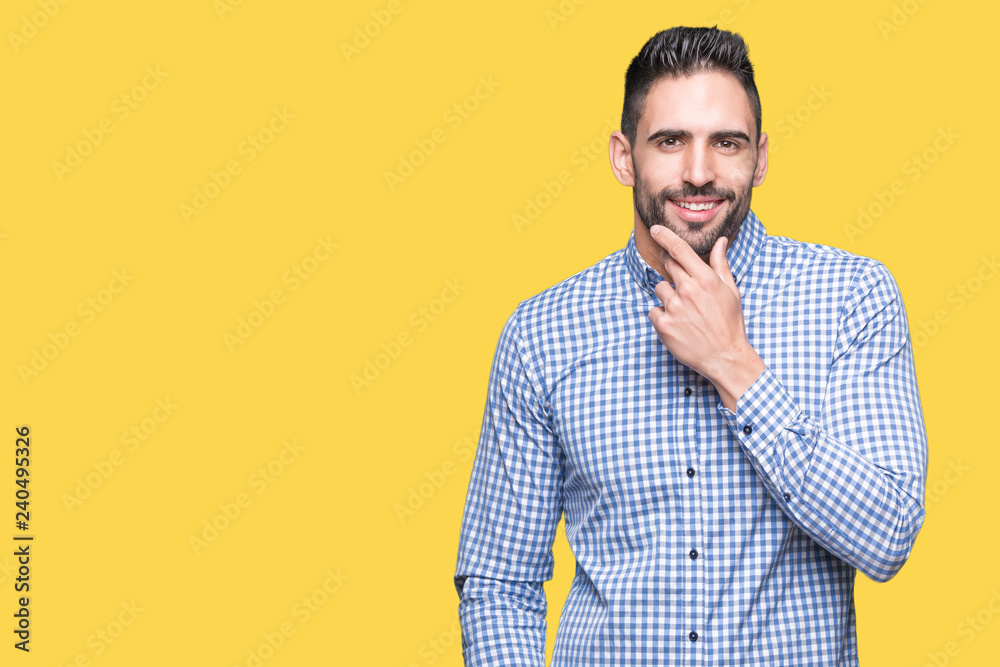 Young handsome man over isolated background looking confident at the camera with smile with crossed arms and hand raised on chin. Thinking positive. Young handsome man over isolated background looking confident at the camera with smile with crossed arms and hand raised on chin. Thinking positive.