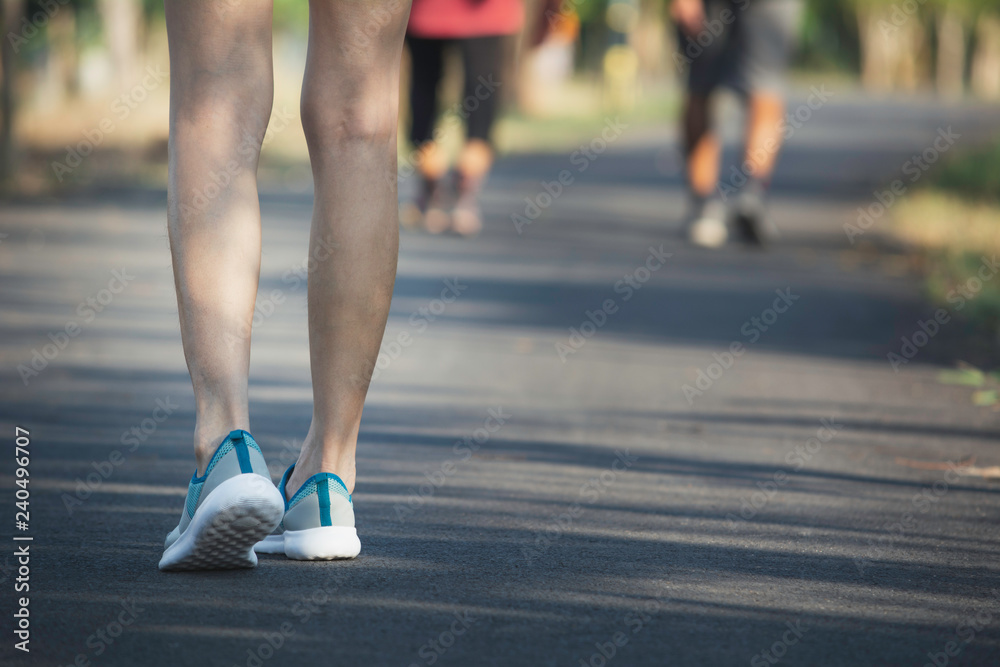 The female walking at the morning for warm up body for jogging and exercise. The female walking at the morning for warm up body for jogging and exercise.