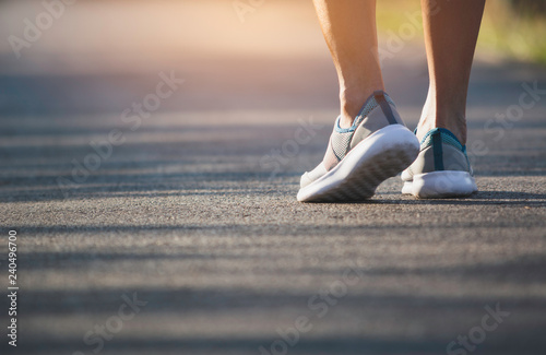 The female walking at the morning for warm up body for jogging and exercise.